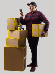 Poster - Business man with boxes. Packer guy holding phone. Businessman stands near packaged goods. Worker uses cardboard packaging. Man calls delivery service. Businessman packed online orders. Stack boxes