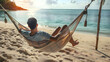 Man lying in a hammock at the beach