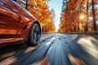 A dynamic perspective of a red sports car driving fast on a road covered with fallen autumn leaves and surrounded by fall forest