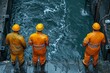 A dynamic image of three workers in vibrant orange safety gear observing a water body on a construction site