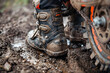 A Pair of Rugged and Durable Motocross Boots Splattered with Adventure Marks