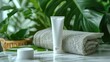 Plastic tube for cosmetics lying between tropical leaves on wicker table top view Package mockup. Blank label for branding mock-up. Natural beauty product concept.