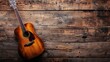 Acoustic guitar on a rustic wooden surface. Copy space for text