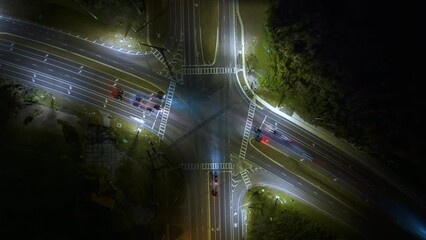 Poster - Wide multilane street intersection with traffic lights and moving cars at night. Timelapse of transportation in USA