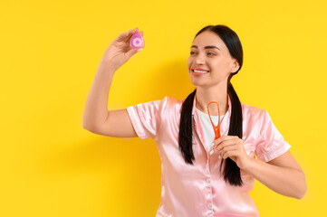 Sticker - Beautiful young happy woman with dental floss and tongue scraper on yellow background