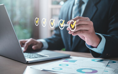 chart, future, job, checkmark, keyboard, management, marketing, multimedia, share, strategy. A man is holding a laptop with a check mark on it. He is wearing a suit and tie.