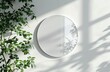 Minimalist Product Presentation Mockup: White Wall with Circular Frame and Plants