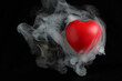 Red love hart flowing flying though white fog smoke mist on black background