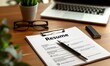 © Dusit - A resume is on a table with a pen and a laptop.