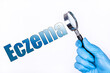 © PRO Balance - A hand in a blue medical glove holds a magnifying glass and points to the text Eczema. Medical concept.