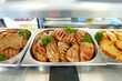 Grilled Chicken Breasts and Pork Cutlets Served in a Buffet Setting