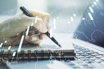 Poster - Multi exposure of abstract creative financial chart with world map and with hand writing in notebook on background with laptop, research and analytics concept