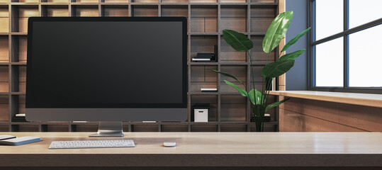 Poster - Close up of clean designer office workplace with empty computer monitor, window with city view and wooden shelves in the background. Mock up, 3D Rendering.