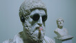 A statue of a man with sunglasses and a bubblegum in his mouth. The statue is surrounded by other statues
