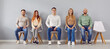 Group portrait of young smart people chair sitting in easy pose, one vacant place left. Diverse new company, together as team, friends gathered showing liking, affection, fellows in good relationships