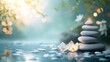 Tranquil spa concept with stacked stones, white orchid flowers, and serene water surface with bokeh lights.