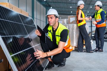 Wall Mural - man in a yellow vest is looking at a solar panel