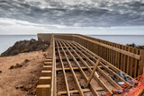 Fototapeta Miasto - Wooden Boardwalk Under Construction On Algarve Coast