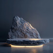 A large rock is lit up with a spotlight, creating a dramatic