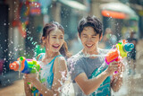 Fototapeta Panele - Happy traveler asian man and woman wearing summer shirt holding colourful squirt water gun over blur city, Water festival holiday concept