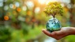 World Earth Day or Arbor Day. Blue glass globe ball and tree in human hand on blurred green background.  Saving environment, save, protect clean planet and ecology., sustainable lifestyle.