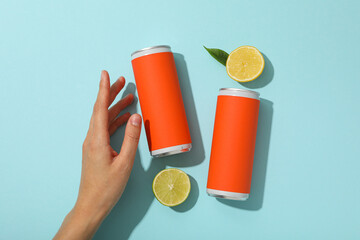 Sticker - Tin can, lemons and hand on blue background, top view