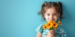 Smiling litle girl in on blue background. Cheerful happy child holding a bouquet of flowers, orange gerberas.
