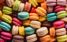 Brightly Colored Macarons In A Row Against A Pastel Background, Symbolizing Sweetness And Indulgence