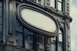 Vintage oval blank store sign on classic building facade at eye level