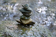 Close-up shot of wet flat stones balancing with blurry background