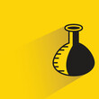 science flask with shadow on yellow background