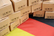 German export concept. Flag of Germany and many carton boxes close up.	