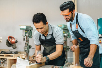 Diligently skilled man work with wood in carpenter's shop, using tools and equipment to transform timber planks into bespoke wooden pieces, craftsmen workshop with natural material, furniture industry