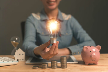Poster - Ideas for saving energy. How to reduce electricity bills and increase savings. Saving money by saving electricity. Ideas for saving money and investing. Businessman holds a light bulb on money