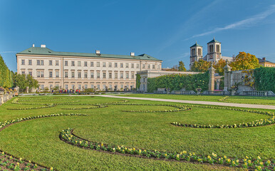 Wall Mural - Salzburg, Austria -  October 6, 2022: The  Mirabell palace and garden with the St Andrew bell tower in the background