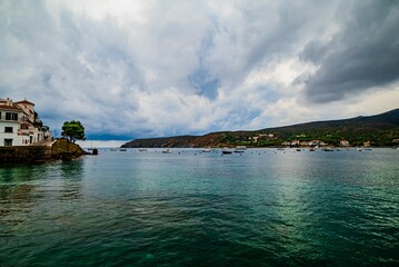 Beautiful shot of a coastline with a background of boats and buildings