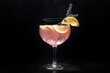 Fancy cocktail with fresh fruit. Gin and tonic drink with ice at a party, on a black background. Alcohol with lavender and lemon