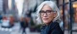 Fototapeta Desenie - Urban Elegance: Graceful Senior Woman Amidst City Lights - Generative AI