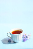 Fototapeta  - cup of hot black tea on a bright spring colors background