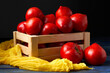 Heap of red, fresh, aromatic, ripe tomatoes with water drops in a wooden box against dark blue background