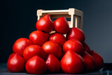 Fototapeta Konie - Heap of red, fresh, aromatic, ripe tomatoes with water drops near a wooden box