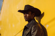 Portrait of young cowboy man posing with cowboy hat, hillbilly teenager, handsome model, ranch style, western