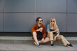 © LIGHTFIELD STUDIOS - couple engaged in a romantic moment, sitting on the curb with coffee