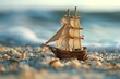 Close up of wooden toy sail ship model in sea sand