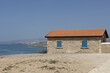 Seaside Stone Cottage Under Clear Blue Sky,