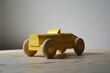 Toy car in yellow wood