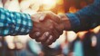 A business partnership handshake is captured in close-up, symbolizing a successful deal or agreement, with a flare effect and blurred setting