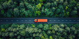 Fototapeta Uliczki - A red semi-truck drives along a highway surrounded by lush green forest from an aerial perspective.