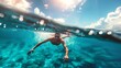 Underwater view of a swimmer with a split surface shot in clear blue water
