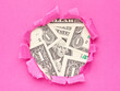 money US dollars in the hole of pink paper